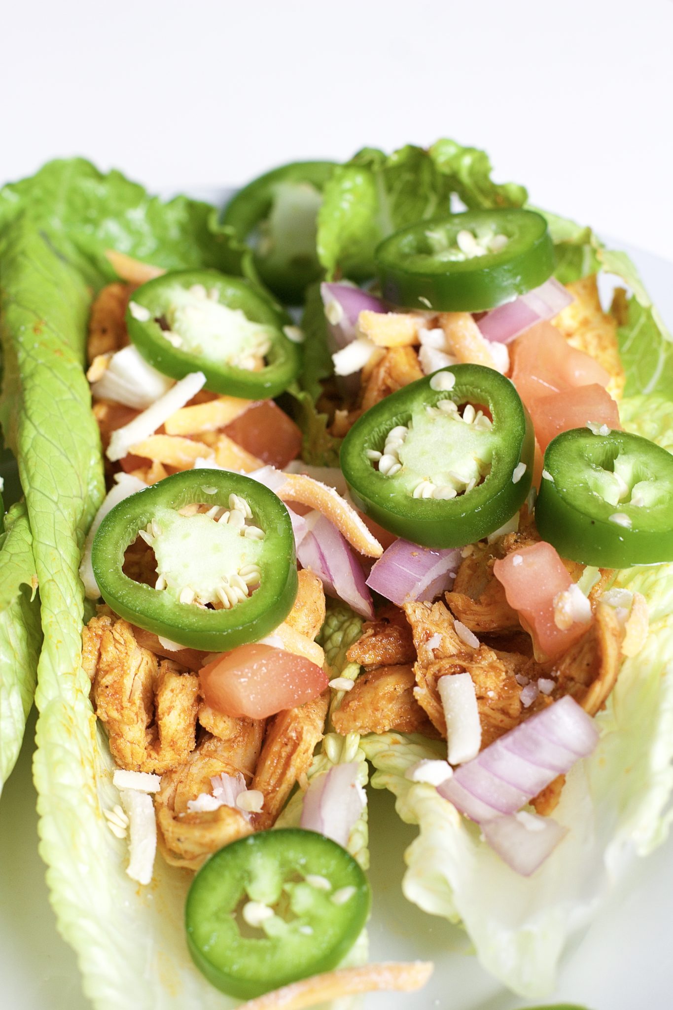 Light, crispy and delicious Buffalo Chicken Lettuce Tacos are made in 20 minutes or less. An easy, gluten-free, low carb, keto and paleo recipe. Enjoy the wraps as an appetizer or main dish. Mexican Recipes | Lettuce Tacos | Chicken Tacos | Spicy | Hot Sauce | Summer Recipe | Game Night | Date Night | Dinner | Low Carb | Ketogenic | Keto | Weight Loss | Buffalo Chicken | Paleo | Easy Dinner | Salad | Romain Lettuce | Lettuce Taco Shells | Lettuce Wraps |