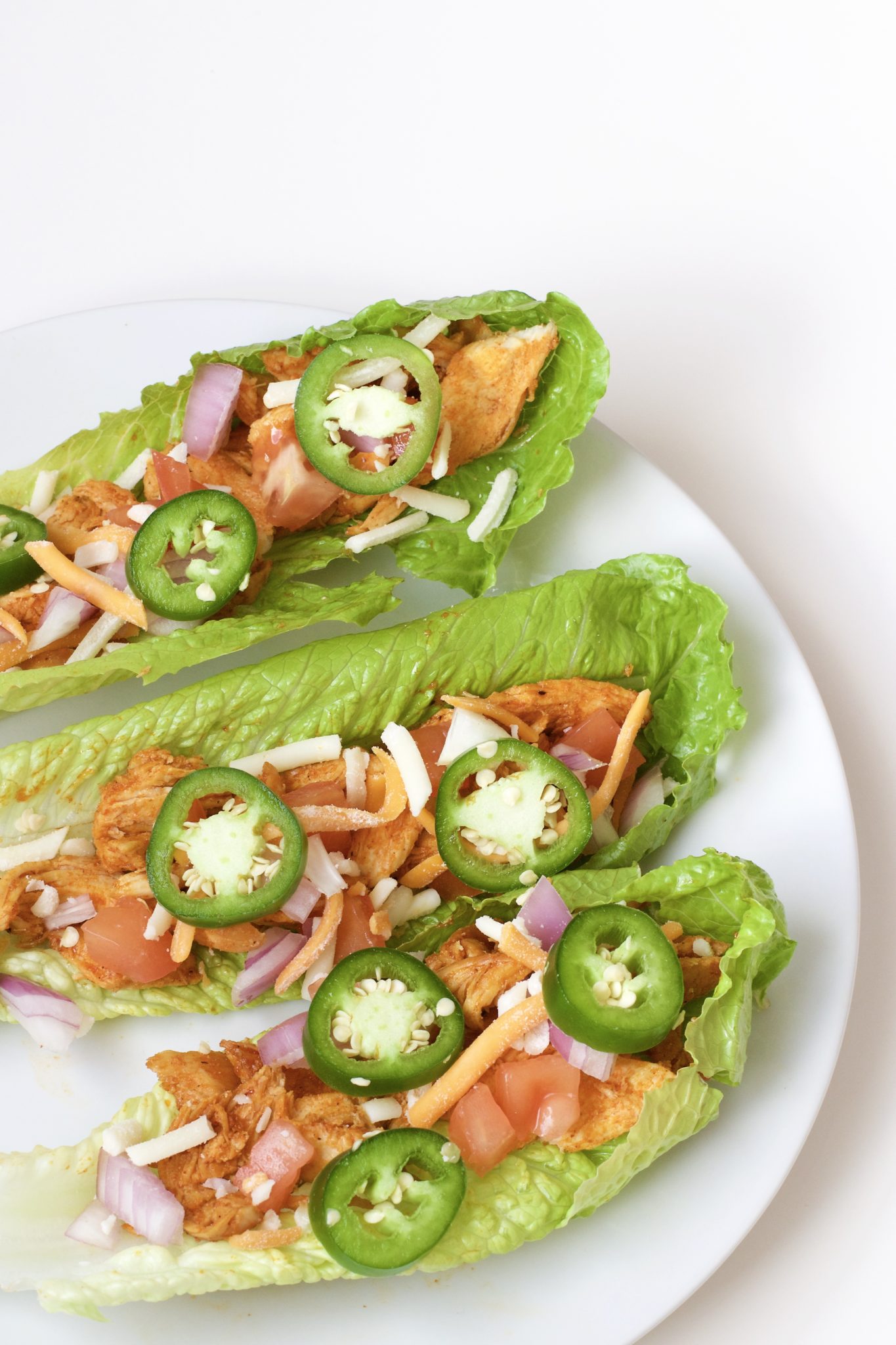 Light, crispy and delicious Buffalo Chicken Lettuce Tacos are made in 20 minutes or less. An easy, gluten-free, low carb, keto and paleo recipe. Enjoy the wraps as an appetizer or main dish. Mexican Recipes | Lettuce Tacos | Chicken Tacos | Spicy | Hot Sauce | Summer Recipe | Game Night | Date Night | Dinner | Low Carb | Ketogenic | Keto | Weight Loss | Buffalo Chicken | Paleo | Easy Dinner | Salad | Romain Lettuce | Lettuce Taco Shells | Lettuce Wraps |