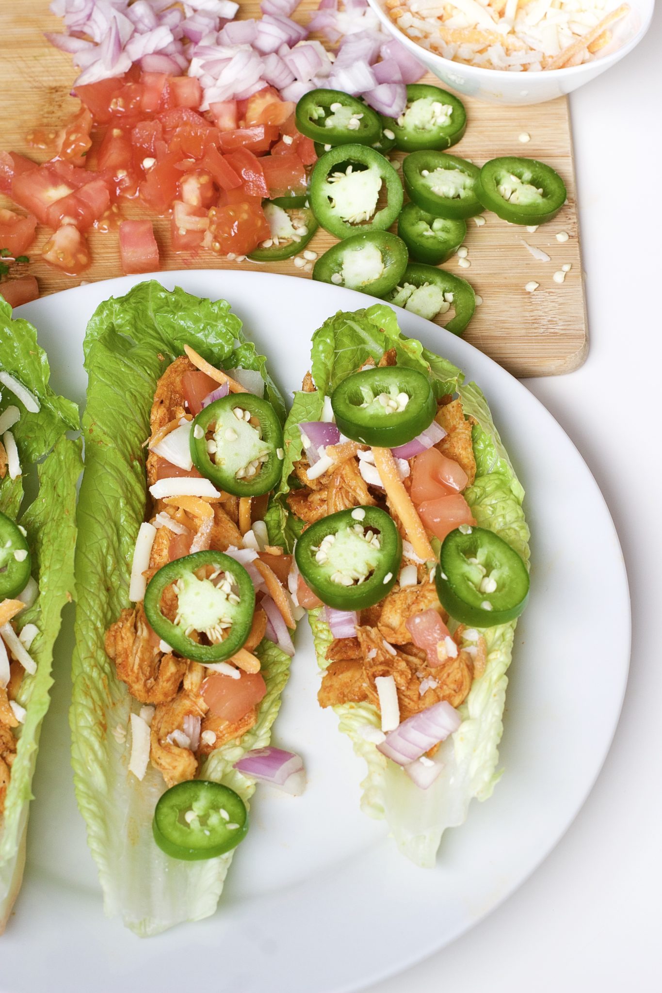 Light, crispy and delicious Buffalo Chicken Lettuce Tacos are made in 20 minutes or less. An easy, gluten-free, low carb, keto and paleo recipe. Enjoy the wraps as an appetizer or main dish. Mexican Recipes | Lettuce Tacos | Chicken Tacos | Spicy | Hot Sauce | Summer Recipe | Game Night | Date Night | Dinner | Low Carb | Ketogenic | Keto | Weight Loss | Buffalo Chicken | Paleo | Easy Dinner | Salad | Romain Lettuce | Lettuce Taco Shells | Lettuce Wraps |