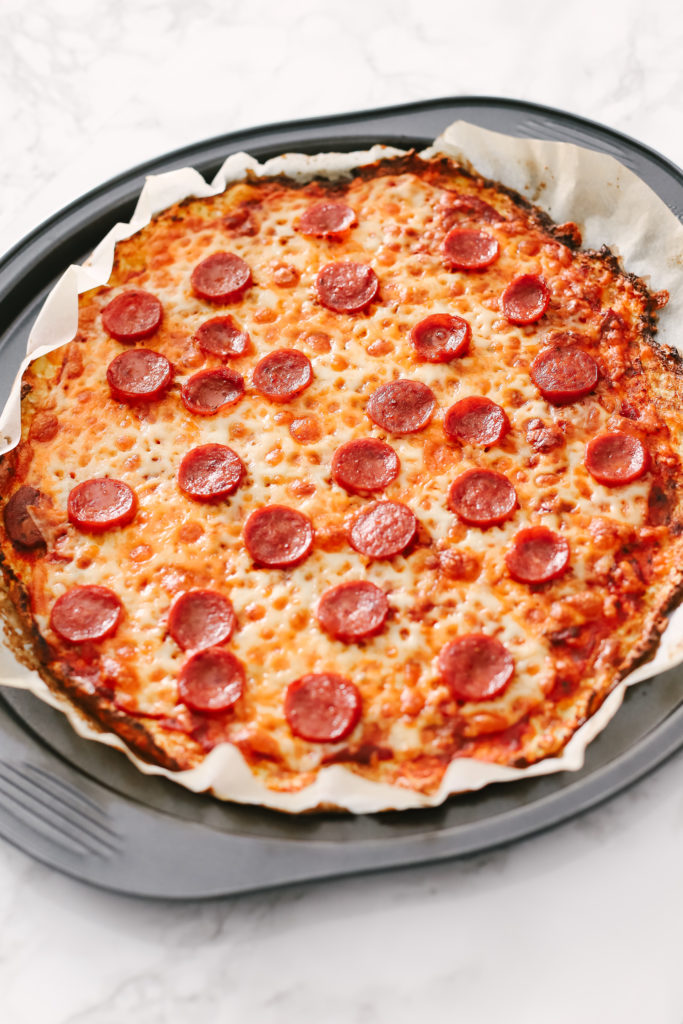 The best cauliflower pepperoni pizza recipe you will ever need to get your pizza fix without the guilt on a low carb, ketogenic diet. It's gluten-free with tons of nutrients and perfect for weight loss. Cauliflower Crust | Cauliflower Pizza | Low Carb | Keto | Keto Dinner Recipe | Easy Pizza Recipe | Healthy Pizza | Super Food Pizza | Keto Food | Keto Dinners | Gluten-Free Pizza | Think Crust | Cheese Pizza | 