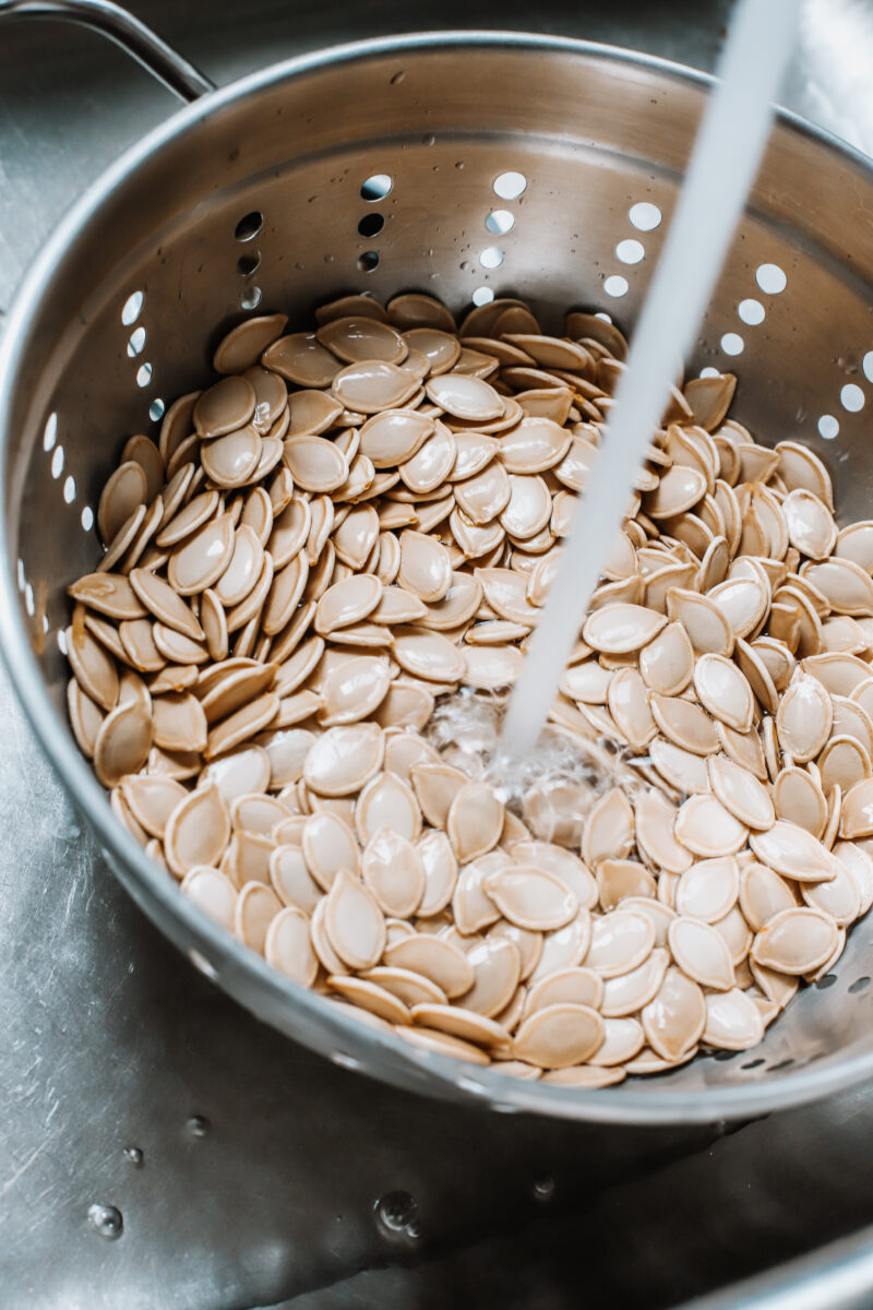 This Easy Salted Roasted Pumpkin Seeds recipe is a delicious and healthy snack after carving pumpkins! A fall and Thanksgiving family tradition you'll want to make year after year with the family!