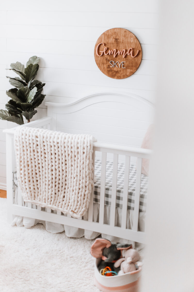 Our baby girl's nursery reveal is here! A sweet and simple modern farmhouse design with a shiplap accent wall and neutral decor. Here are all of the details! Gender Neutral | Farmhouse Nursery | Shiplap Crib | All White Nursery | Baby's Name | Wooden Sign | Chunky Knit Chenille Blanket | Home Design | Interior | Northern Living | Canadian Living | Canadian Small Shops | Small Businesses | Baby's Room |