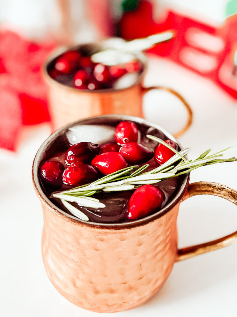 This Cranberry Moscow Mule in a copper mug is a festive cocktail for Christmas that's sugar free, keto friendly, gluten-free and low carb. A refreshing drink to keep you relaxed while staying on track this holiday season. Christmas Recipe | Adult Beverages | Mocktail Version | Drinks | Cocktails | Festive Drink | Christmas Drink | Keto Cocktail | Keto Moscow Mule |