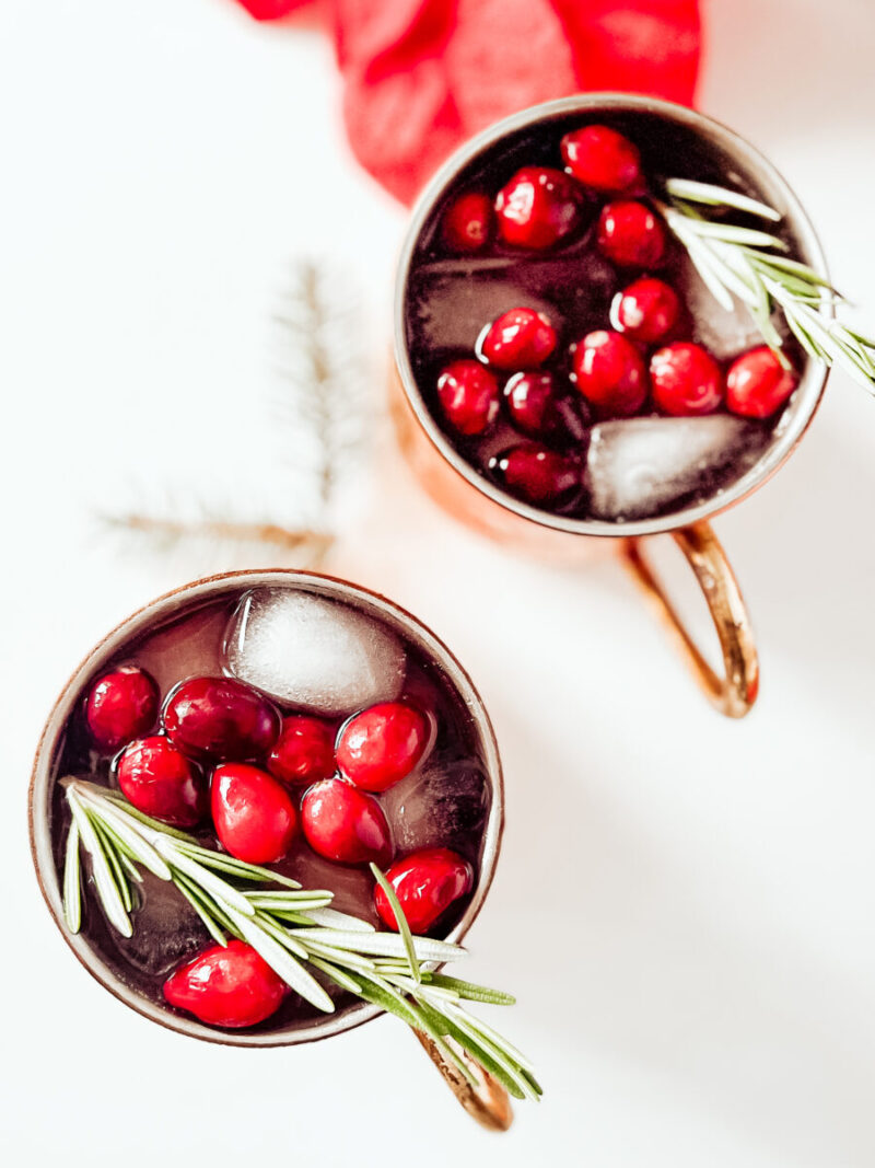 This Cranberry Moscow Mule in a copper mug is a festive cocktail for Christmas that's sugar free, keto friendly, gluten-free and low carb. A refreshing drink to keep you relaxed while staying on track this holiday season. Christmas Recipe | Adult Beverages | Mocktail Version | Drinks | Cocktails | Festive Drink | Christmas Drink | Keto Cocktail | Keto Moscow Mule | 