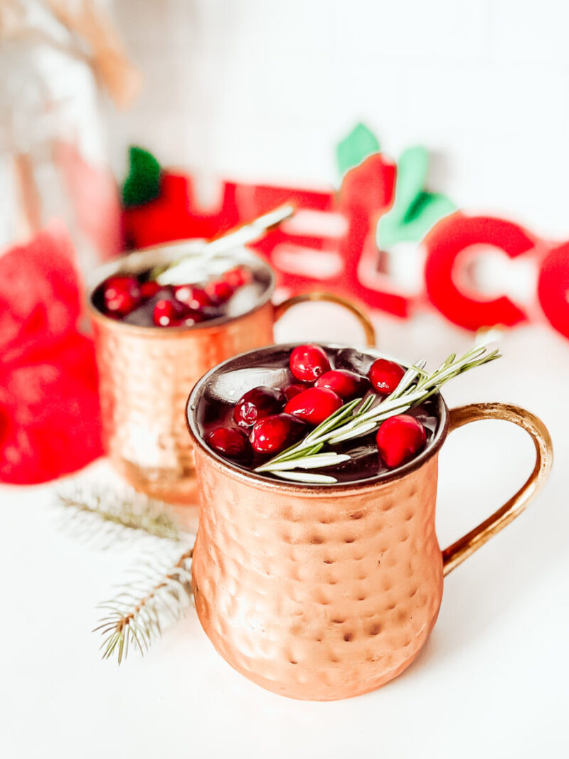 This Cranberry Moscow Mule in a copper mug is a festive cocktail for Christmas that's sugar free, keto friendly, gluten-free and low carb. A refreshing drink to keep you relaxed while staying on track this holiday season. Christmas Recipe | Adult Beverages | Mocktail Version | Drinks | Cocktails | Festive Drink | Christmas Drink | Keto Cocktail | Keto Moscow Mule |