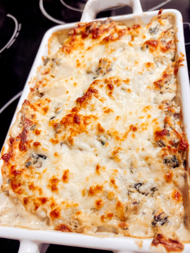 This easy Mushroom Spinach and Artichoke Dip is hearty, satisfying, and made with only a few ingredients. Creamy and delicious, serve as an appetizer or the perfect low carb, keto snack. Game Night Get Together Holiday Snack Dips Oven Baked Cheesy Healthy Easy Appetizers Family gatherings