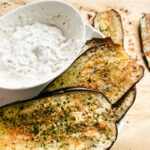 This Oven Roasted Eggplant with garlic and parmesan is baked to perfection and served with a Mediterranean dip. Delicious, healthy, and a quick and easy dinner or side dish that's gluten-free, low carb and keto friendly. Dinner Recipes | Dinner Side Dish | Greek Recipes | Italian Recipes | Eggplant Recipe | Oven Baked | Homemade Dip | Appetizer | Healthy Meals | Easy Dinners