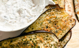 This Oven Roasted Eggplant with garlic and parmesan is baked to perfection and served with a Mediterranean dip. Delicious, healthy, and a quick and easy dinner or side dish that's gluten-free, low carb and keto friendly. Dinner Recipes | Dinner Side Dish | Greek Recipes | Italian Recipes | Eggplant Recipe | Oven Baked | Homemade Dip | Appetizer | Healthy Meals | Easy Dinners