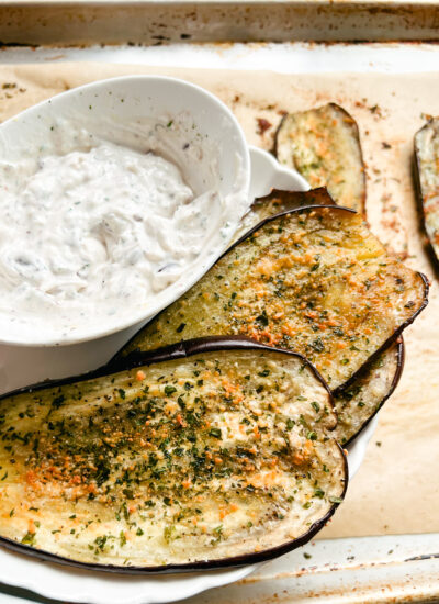 This Oven Roasted Eggplant with garlic and parmesan is baked to perfection and served with a Mediterranean dip. Delicious, healthy, and a quick and easy dinner or side dish that's gluten-free, low carb and keto friendly. Dinner Recipes | Dinner Side Dish | Greek Recipes | Italian Recipes | Eggplant Recipe | Oven Baked | Homemade Dip | Appetizer | Healthy Meals | Easy Dinners