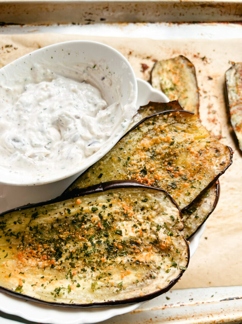 This Oven Roasted Eggplant with garlic and parmesan is baked to perfection and served with a Mediterranean dip. Delicious, healthy, and a quick and easy dinner or side dish that's gluten-free, low carb and keto friendly. Dinner Recipes | Dinner Side Dish | Greek Recipes | Italian Recipes | Eggplant Recipe | Oven Baked | Homemade Dip | Appetizer | Healthy Meals | Easy Dinners