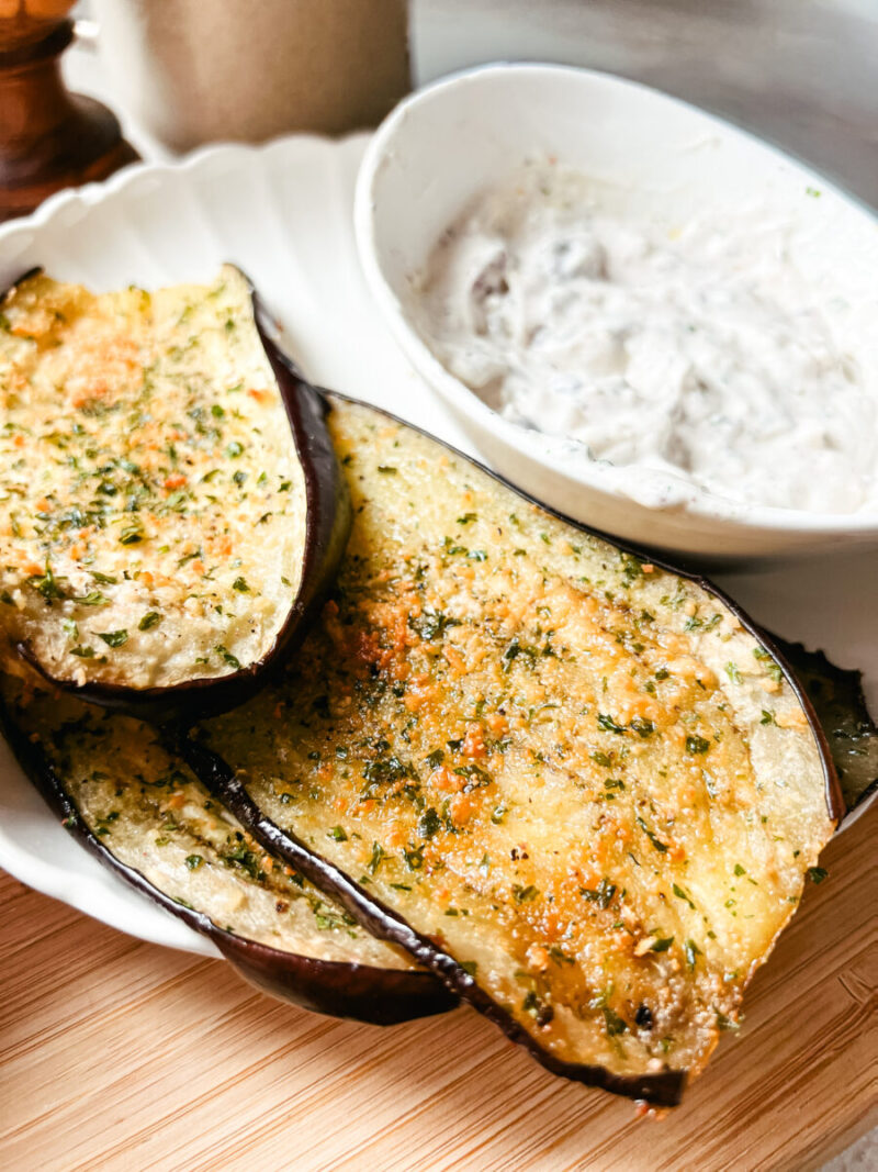 This Oven Roasted Eggplant with garlic and parmesan is baked to perfection and served with a Mediterranean dip. Delicious, healthy, and a quick and easy dinner or side dish that's gluten-free, low carb and keto friendly. Dinner Recipes | Dinner Side Dish | Greek Recipes | Italian Recipes | Eggplant Recipe | Oven Baked | Homemade Dip | Appetizer | Healthy Meals | Easy Dinners 