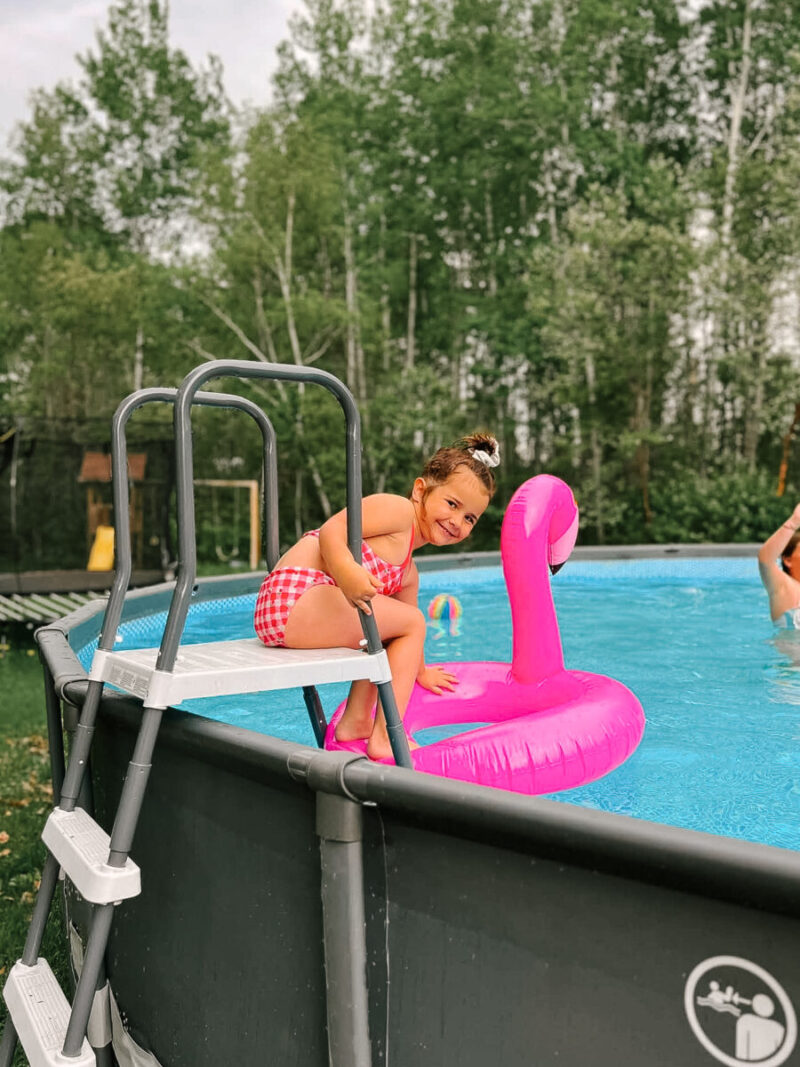 Child climbing the ladder into our Intex Ultra XTR above ground pool