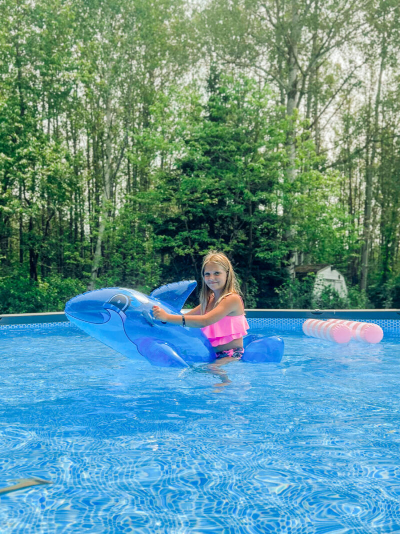 Kids playing with a ride on float in our Intex Ultra XTR pool