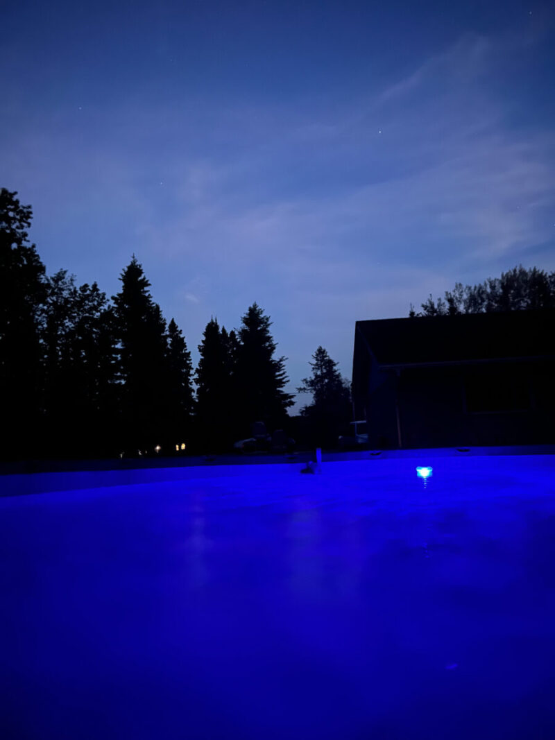 Intex Ultra XTR above ground pool illuminated with blue lights at night